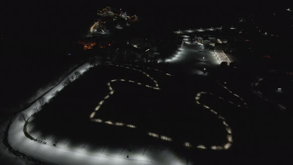 Flying at night over rope-way with gondolas at mountain resort Crystal Park in Bakuriani.  alt