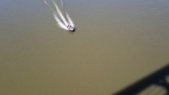 Powerboat Sailing Fast On A River In City Aerial View
