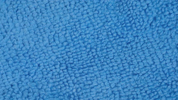 Blue Microfiber Cleaning Cloth on Rotating Surface  Close Up