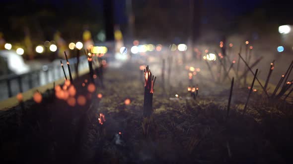 Video Recording of Smoldering Aroma Sticks in Dark Interior of Buddhist Temple