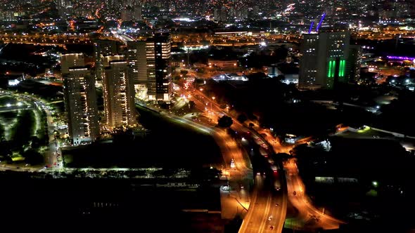 Night city landscape at downtown district. Buildings and traffic. alt