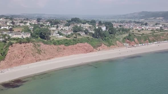 Coastline view from the sky of Seaton England. Beautiful beach and town visible from the sky. White alt