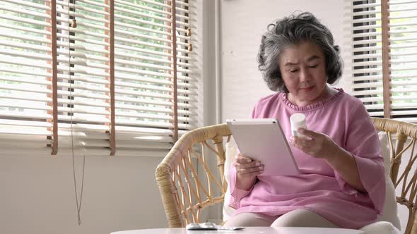 Senior woman with medicine and tablet