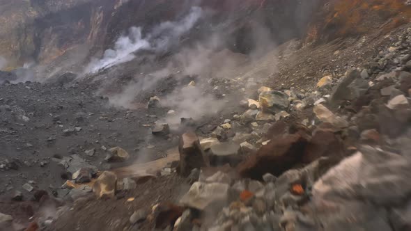 Close Up of Stones, Rocks and Ash with Gas in Crater of Volcano alt