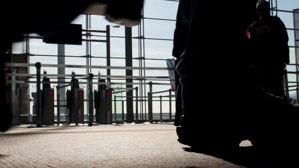 Silhouettes of People Walking by Gates at Airport Terminal, Flight, Bottom View alt