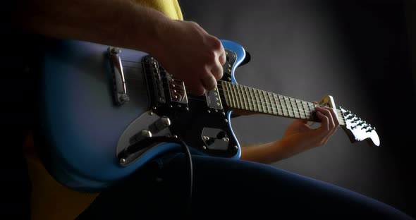 Male Guitaris Tplaying Fingerpicking in Blue Electric Guitar alt