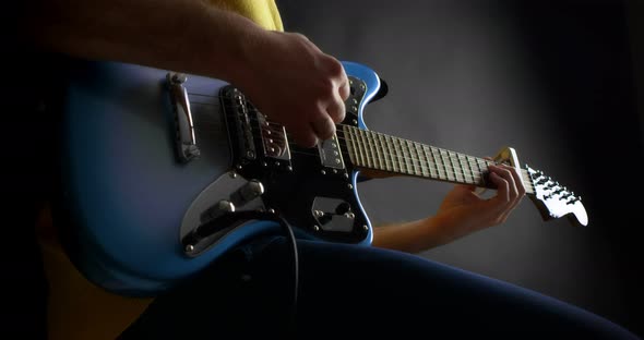 Male Guitaris Tplaying Fingerpicking in Blue Electric Guitar