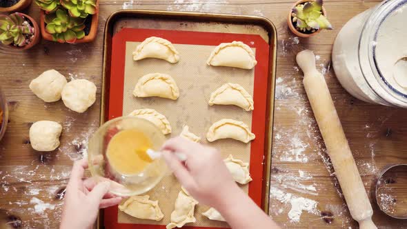 Flat lay. Step by step. Making home made sweet empanadas with red apples. alt