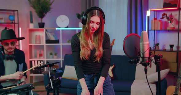 Male Drummer and Female DJ Recording at Home Studio Instrumental Parts for Club Party alt