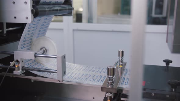 Automated Pharmaceutical Equipment is Manufacturing the Blister Pack for Pills at Chemical Plant
