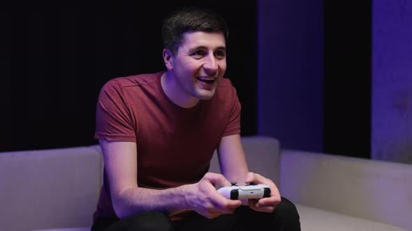 Caucasian Guy Playing Video Game and Using Joystick