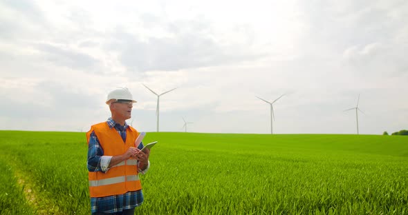 Male Engineer Working While Holding Blueprint alt