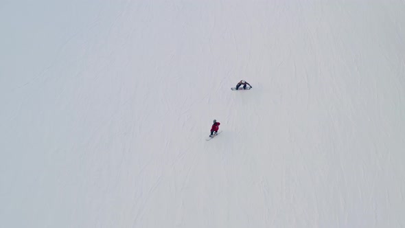 people skiing in the thick snowy trail of Bialy Potok Zima. Aerial alt