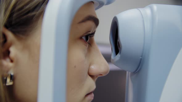 The Ophthalmologist Examines the Patient's Eye and Then Looks Into the Camera alt