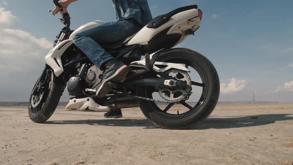 Man Biker Doing Tire Burnout in the Desert Slow Motion alt