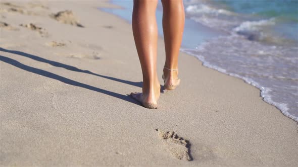 Female Feet on White Sandy Beach Background the Sea