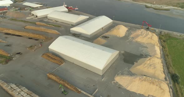 Sawdust and Piles of Tree Logs Timber in Cargo Ship Port Aerial View alt