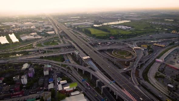 Aerial View of Highway Road Interchange with Busy Urban Traffic Speeding on Road alt