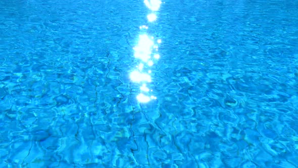 Pure blue water in the swimming pool. Ripple and waves in the clear turquoise water.