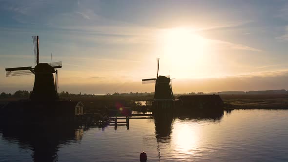 Windmills at Zaanse Schans, aerial silhouette view. Famous place to visit in Amsterdam, Netherlands.