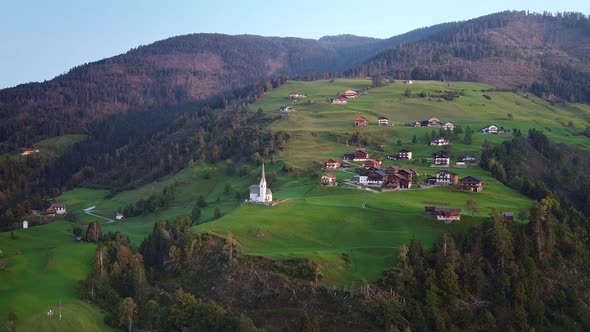 Aerial View of Villas and Church on Austrian Mountains alt