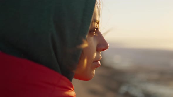 Close Up Portrait of Young Adult Woman Traveler Looking at Sunrise at Sea Beach alt