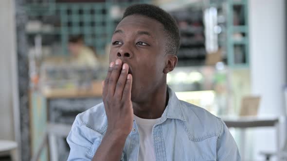Sleepy African Man Yawning alt