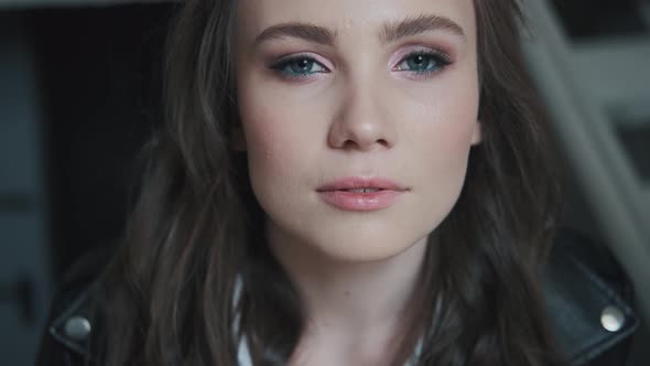 Closeup Portrait of an Attractive Girl with Bright Blue Eyes. alt