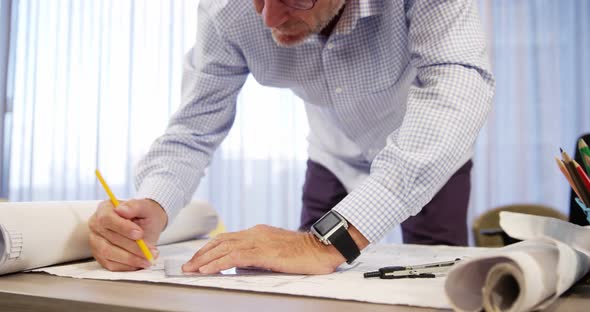 Architect working on blueprint alt