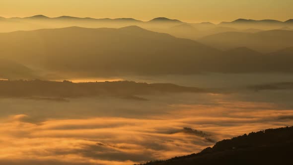 Time Lapse Fog Floating In Mountain Valley During Golden Hour