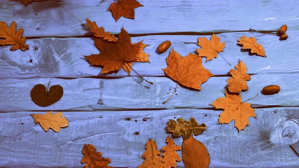 Vintage Autumn Background With Yellow Foliage In Slow Motion The Foliage Falls On A Wooden Table