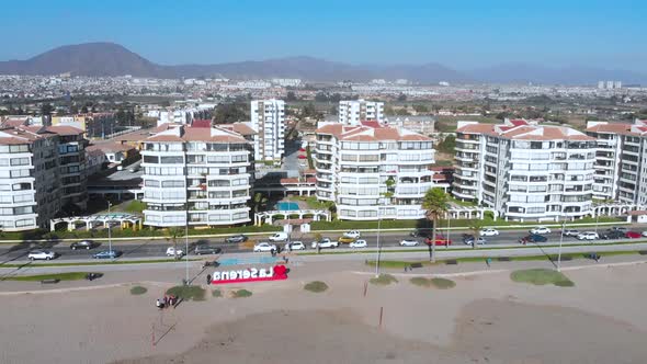 First line buildings, Beach pacific ocean coast (La Serena, Chile) aerial view alt