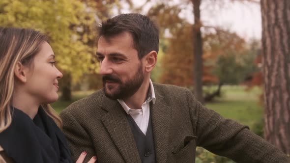 Handsome young couple walking in the autumn park