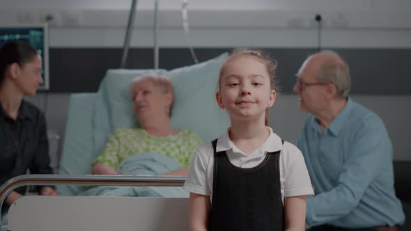 Portrait of Young Child Standing in Hospital Ward at Clinic alt