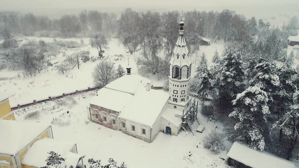 Majestic Winter Village Landscape with Wooden Houses and a Church Aerial View alt