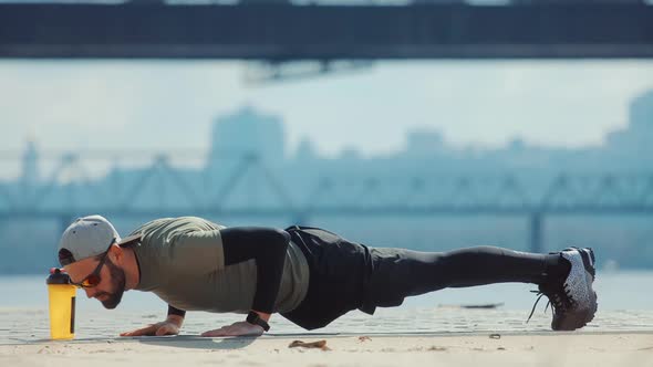 Man Limbering-Up And Stretching Legs After Running Jog Workout. Runner Stretching And Warming-Up. alt