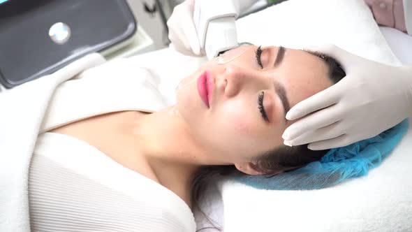 Young Asian Woman Getting IPL and Laser Treatment By Beautician at Clinic alt