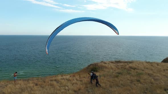 Paraglider Is Landing on the Beach, Aerial View on the Sea alt
