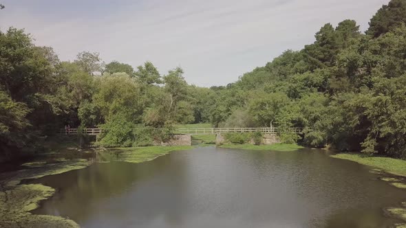 Joggers on a small bridge in a beautiful park 4K