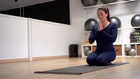 Tranquil woman meditating in yoga pose alt