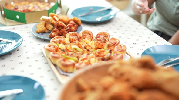 4K African family eating fried chicken and pizza for dinner together at home