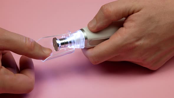 Man assembling the electric manicure device for nail care