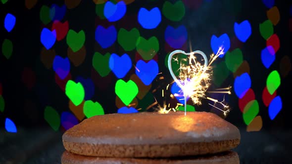 Hand Igniting Heart Shapped Sparkler Placed on a Simple Cake to Celebrate Valentines Day