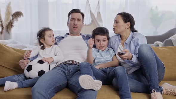 Friendly Family with Kids Watching TV at Home alt