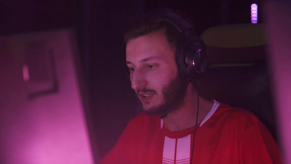 Portrait of a Focused Man Gamer in Headphones Plays a Video Game Cyber Sportsman at the alt