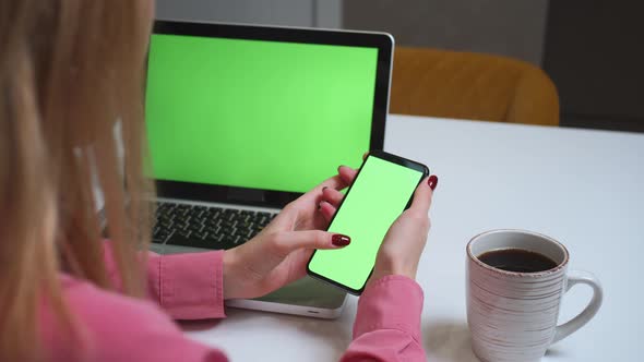 Close Up Woman Using Smartphone Green Screen on the Table with Laptop Computer Chromakey alt