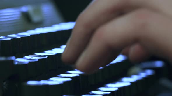 A man typing on a typewriter