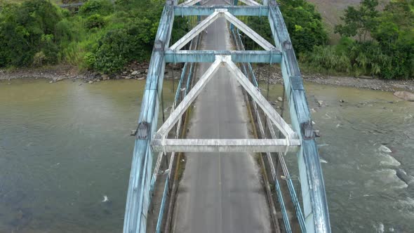 Aerial top view of a metal truss bridge alt