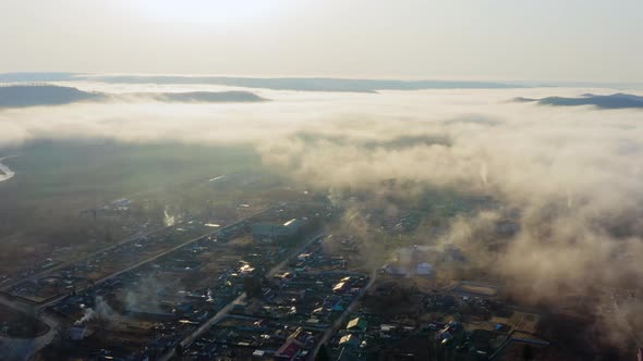 Flight Over the Valley Covered with Morning Mist in the Countryside alt