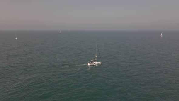 Yacht with Reflection Sailing on Open Sea Aerial